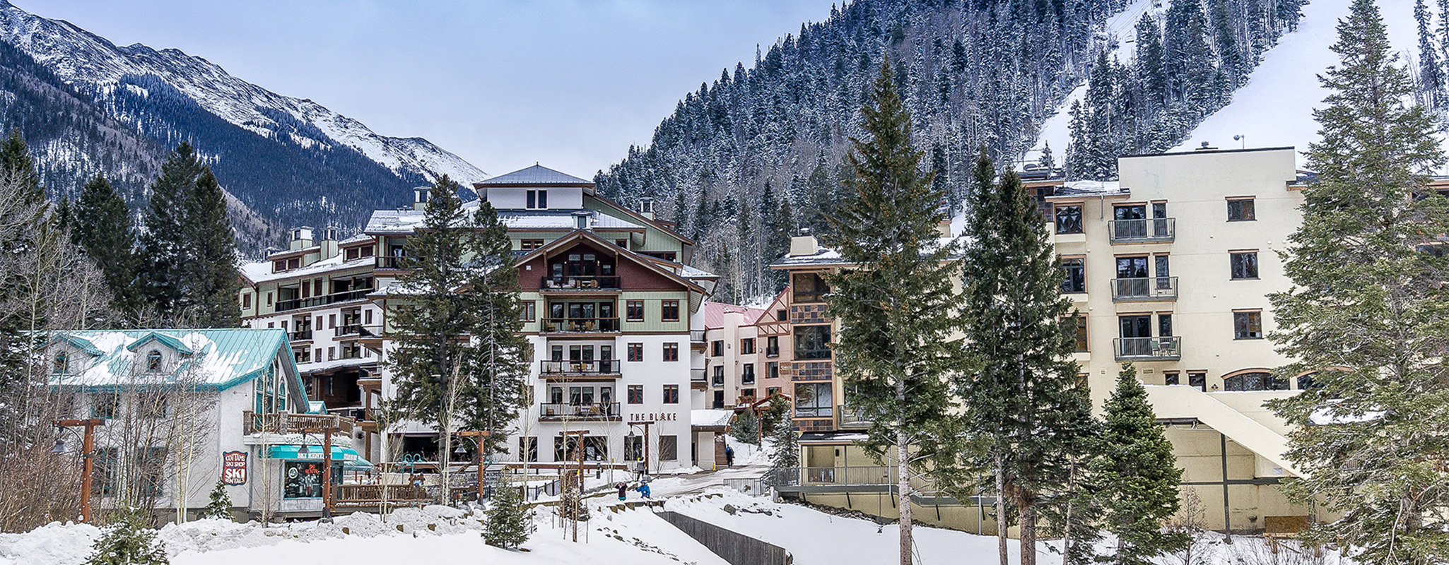 The snow covered village of Taos Ski Valley with mountains rising on both sides