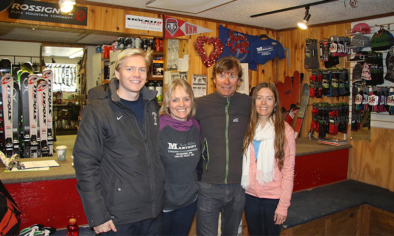 A smiling family in a ski shop