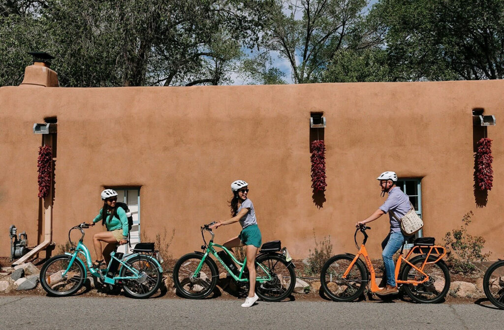 A group of cyclist on cruiser bikes stop in a line for a chat