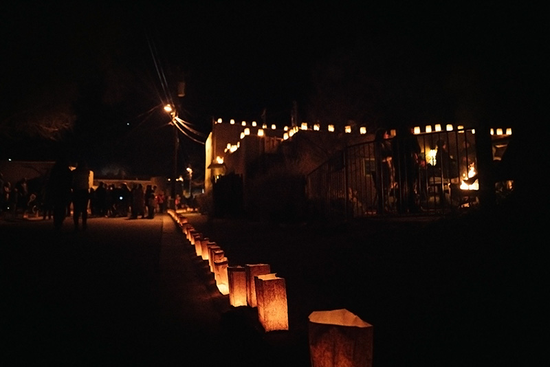 Traditional farolitas line the tops of buildings and the sidewalks at Christmastime.