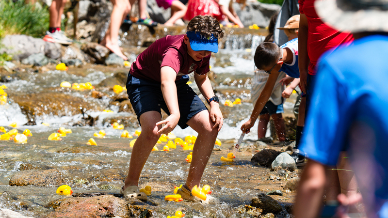 People in river with rubber ducks