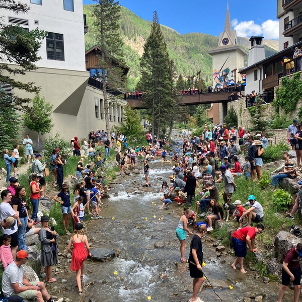 People and rubber duckies in a river