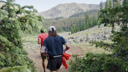 2 people running on a trail