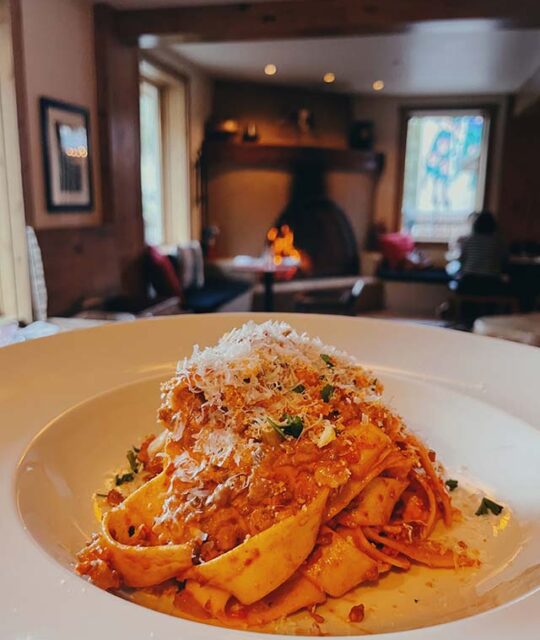 Pasta entree served at the 192 with fireplace in the background