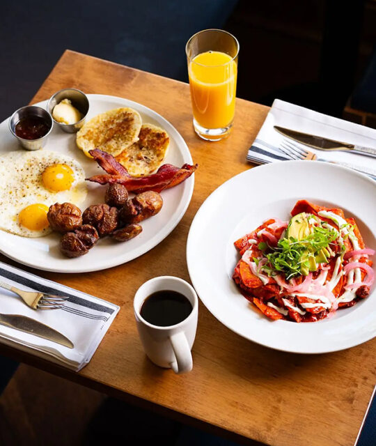 Breakfast, brunch plates, coffee and orange juice.