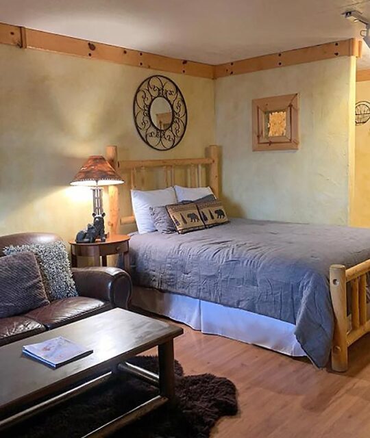 A vacation rental with a log framed bed.
