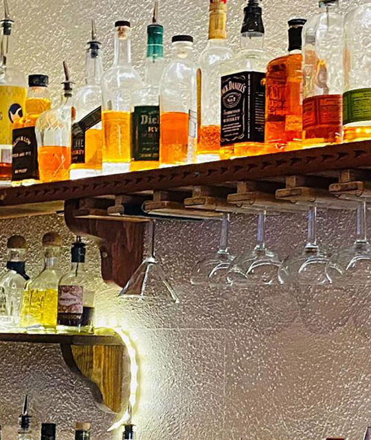 Liquor bottles on shelf behind bar