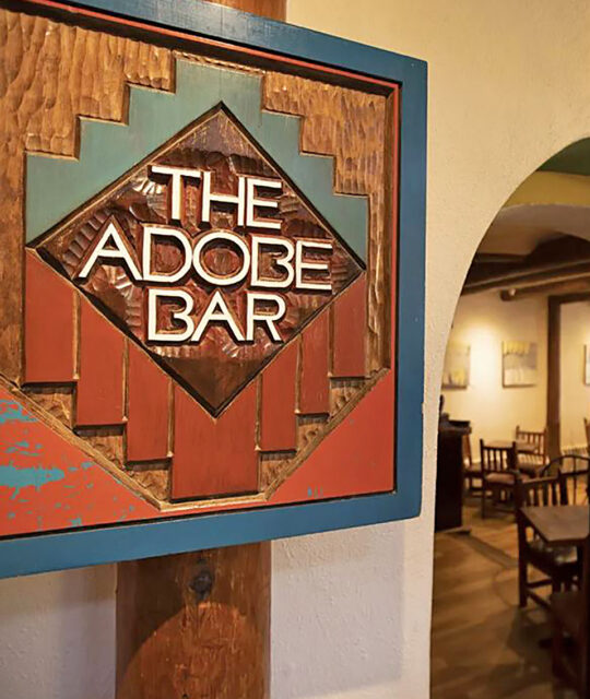 The Adobe Bar southwestern carved entrance sign