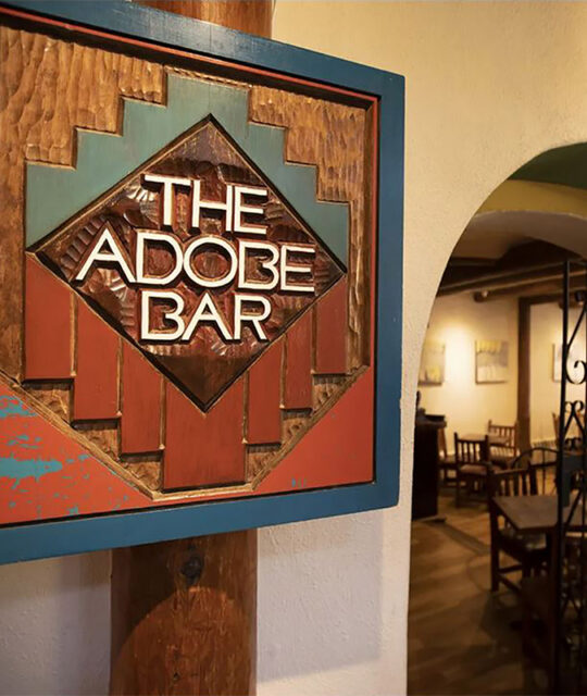 The Adobe Bar southwestern carved entrance sign