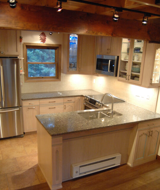 A bright, clean kitchen with gray granite countertops