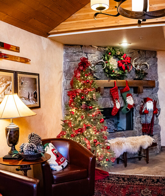 Holiday decor and fireplace at a ski lodge.