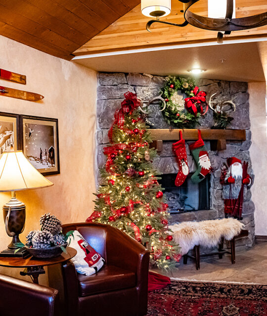 Holiday decor and fireplace at a ski lodge.