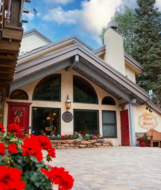 Alpine Village Suites entrance on a sunny summer day in Taos Ski Valley