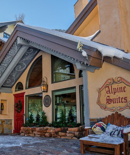 Alpine Village Suites entrance and snow in Taos Ski Valley