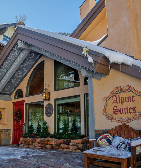 Alpine Village Suites entrance and snow in Taos Ski Valley