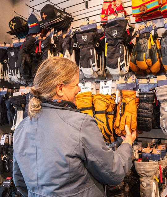 Woman looking at ski gloves and mittens.