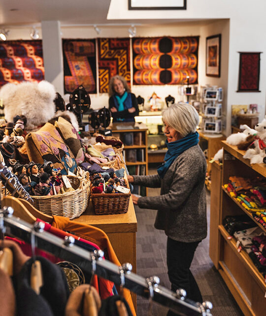 Woman shopping in boutique South American imports, Andean Software.