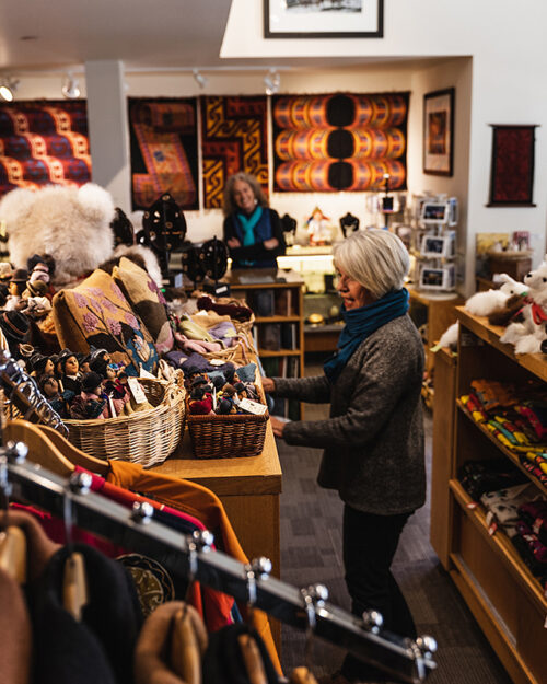 Woman shopping in boutique South American imports, Andean Software.