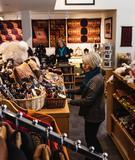 Woman shopping in boutique South American imports, Andean Software.