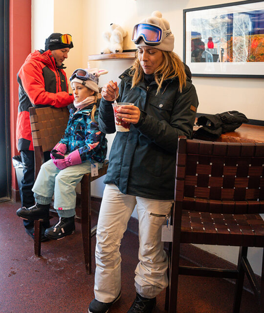 Family in ski gear in an espresso bar.