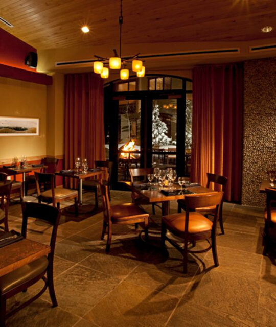 A dramatically lit restaurant dining room