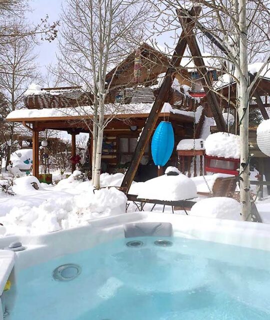 Outdoor hot tub in the snow at Casa Carmen