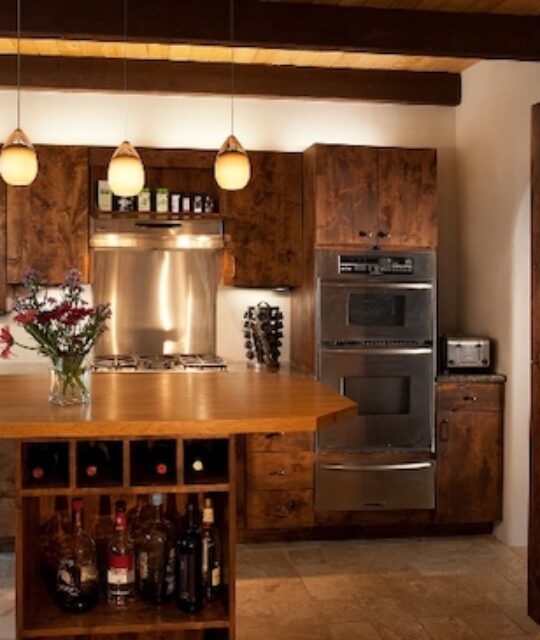 Modern kitchen with wood accents and central island bar.