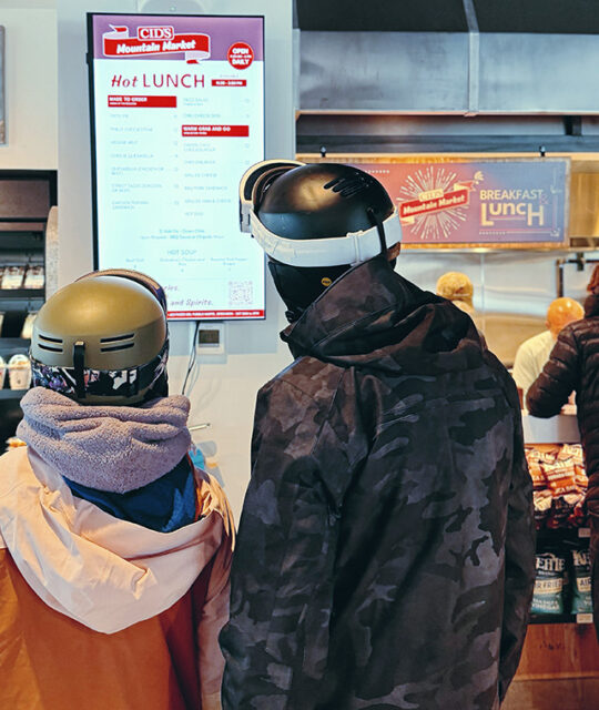 Customers viewing Cid's Mountain Market Kitchen hot food menu