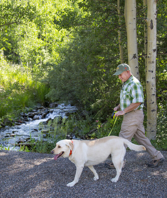 Man with dog on a hike in the forest