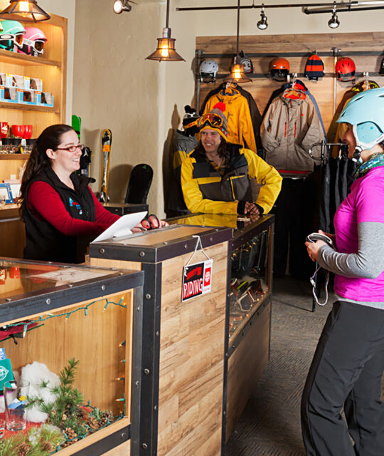 Cottam's Ski Shop Woman browsing at in Taos Ski Valley