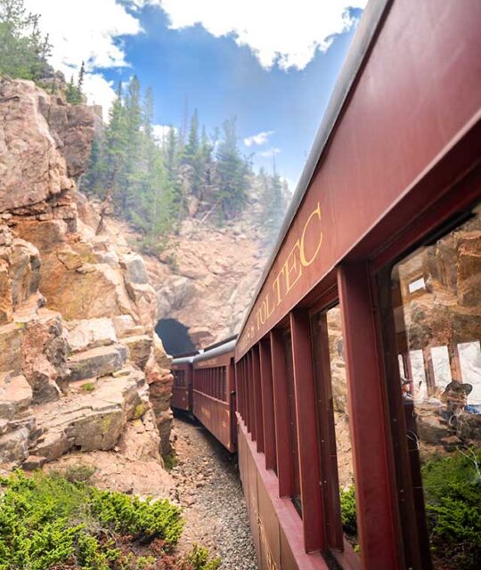 The historic Cumbres & Toltec scenic railroad entering a tunnel.