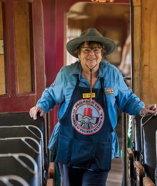 A smiling woman volunteer for the Cumbres & Toltec Scenic Railroad.