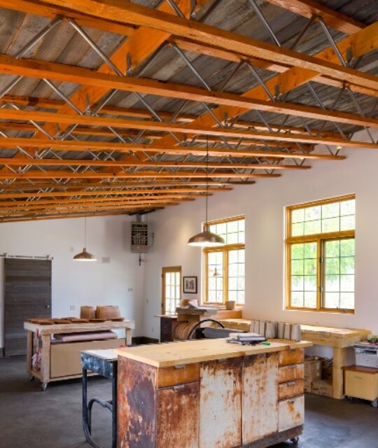 Office and studio space with exposed beams and high ceilings.