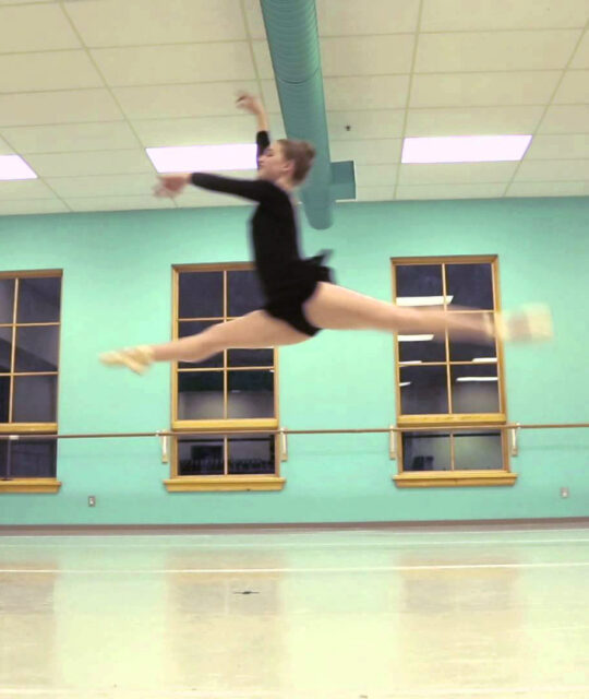 A ballet dancer leaps in the air