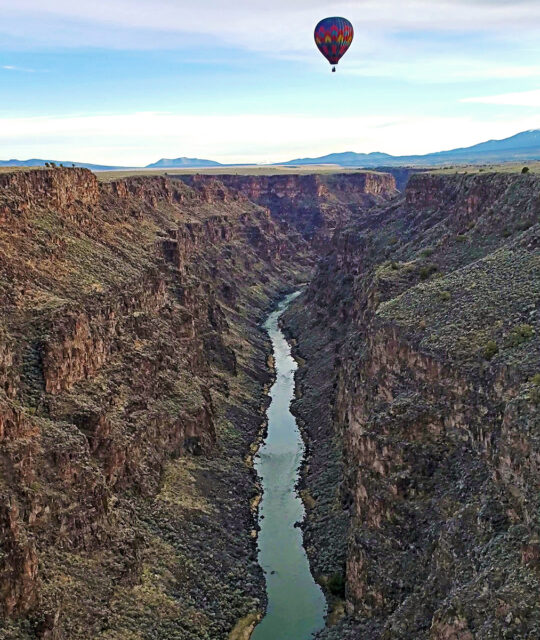 View of hot air balloon over Taos' Rio Grande Gorge.