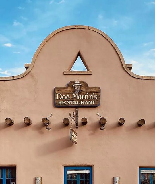 The Historic Taos Inn Doc Martin's Restaurant sign adobe exterior.