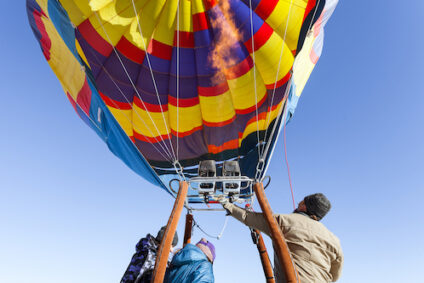 Close up view under the ignited torch and filling the hot air balloon.