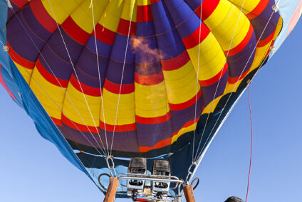 Close up view under the ignited torch and filling the hot air balloon.