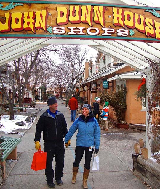 Holiday shoppers in the snow at the John Dunn Shops