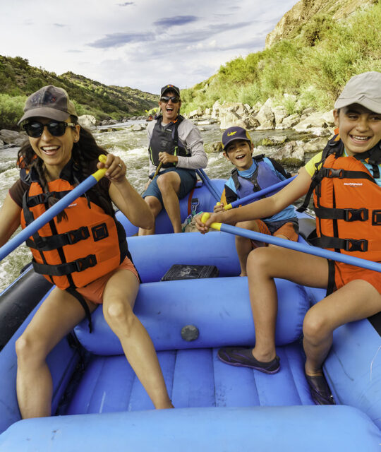 Family on guided raft trip on the Rio Grande Racecourse section near Pilar, New Mexico