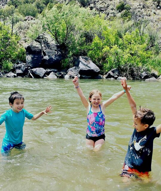 Kids playing in a river at a summer camp