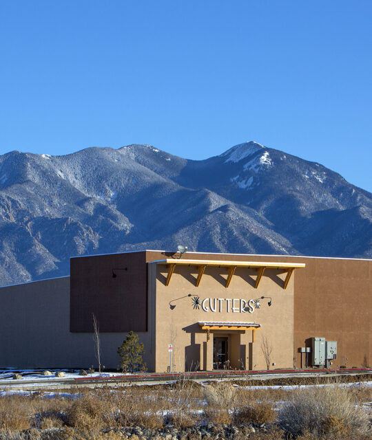 Gutters Bowling Alley with Taos' snowy Sangre de Cristo mountains in background