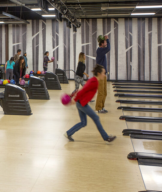 Families and groups bowling and hanging out at Gutters Bowling Alley