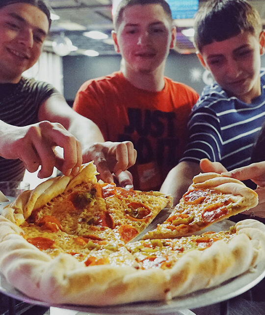 Young people enjoying a pizza