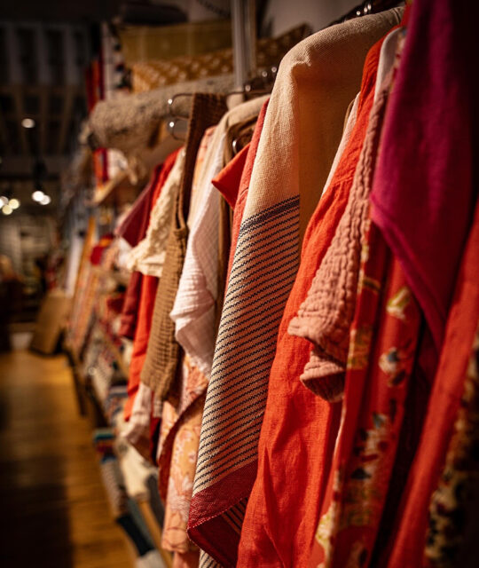 Colorful display rack of women's clothing.
