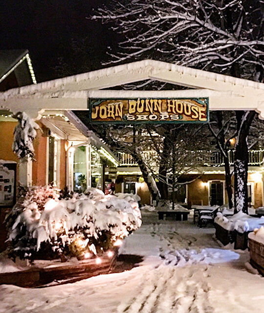 Holiday lights and snow at the John Dunn Shops entrance