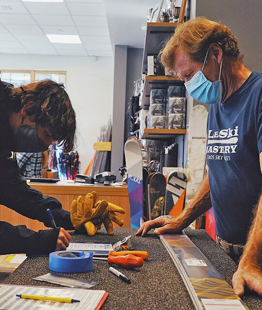 Alain Veth and customers signing up for gear rentals