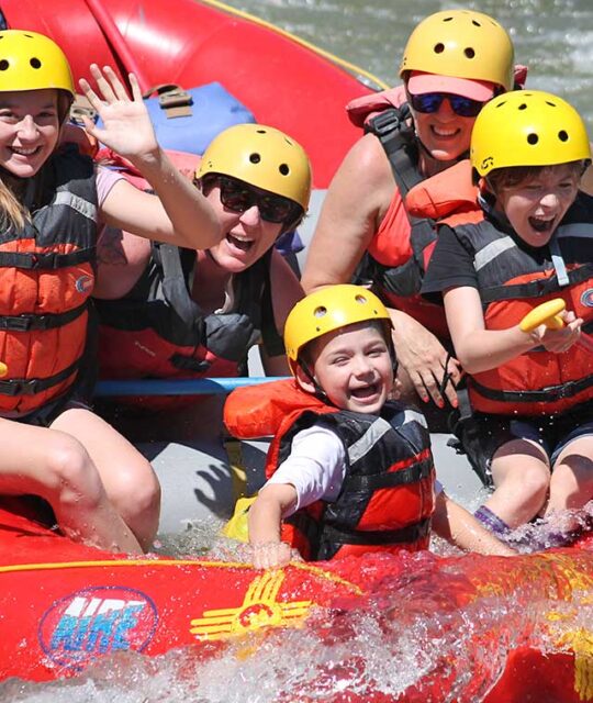 Family having fun on a rafting trip.