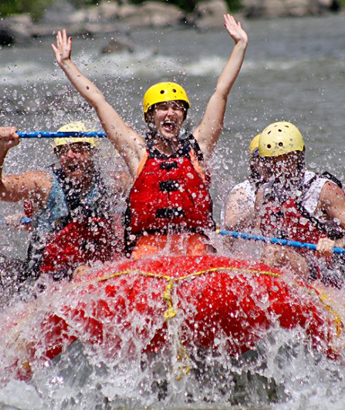 Exuberant woman in river raft