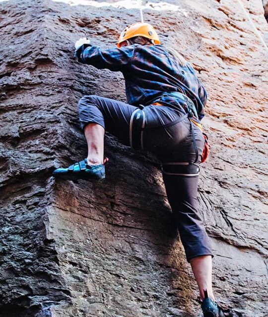 Woman rock climbing the Rio Grande Gorge with New Mexico River Adventures.